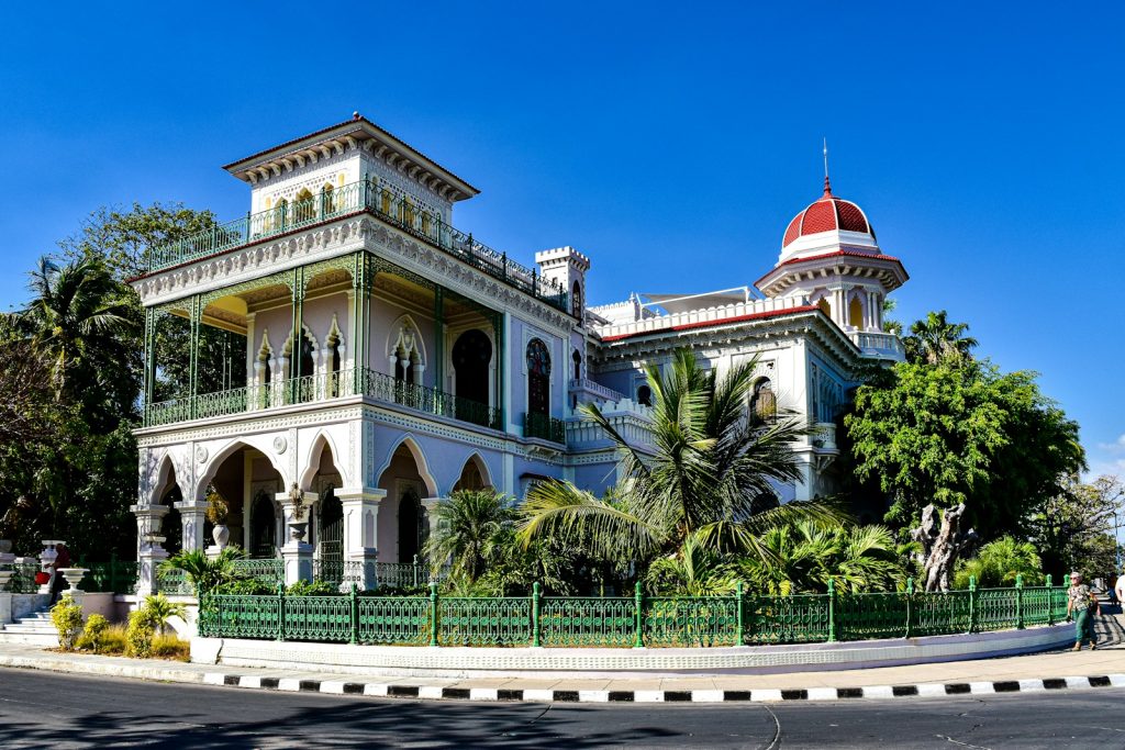 Beautiful cuban architecture stands under a bright blue sky.